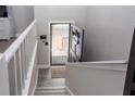 Bright entryway featuring a welcoming front door, gray wood flooring, and white railings at 1220 Wade Green Nw Cir, Acworth, GA 30102