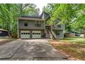 Charming two-story home with gray siding, a two-car garage, and a welcoming front porch at 1220 Wade Green Nw Cir, Acworth, GA 30102
