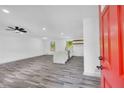 The front door opens into a light-filled living room with gray wood flooring, recessed lights, and an island at 5200 Beechwood Forest Ct, Lithonia, GA 30038