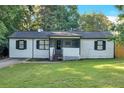 Classic home exterior with white siding, black shutters, and a cozy screened-in front porch at 54 Mildred Ct, Dallas, GA 30157