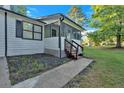 Close-up of home with a welcoming screened-in porch with stairs, great curb appeal at 54 Mildred Ct, Dallas, GA 30157