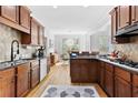 Modern kitchen featuring wood cabinets, granite countertops, and stainless steel appliances at 6069 Queens River Dr, Mableton, GA 30126