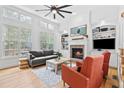Bright living room with a fireplace, built-in shelves, hardwood floors and large windows at 6069 Queens River Dr, Mableton, GA 30126
