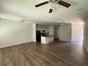 Spacious living room features a kitchen island and modern ceiling fan at 6446 Grey Fox Way, Riverdale, GA 30296