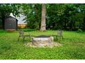 Backyard with fire pit area and chairs, perfect for relaxing or entertaining at 670 Parker Ave, Decatur, GA 30032