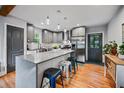 Modern kitchen featuring gray cabinets, stainless steel appliances, and a large island with seating at 670 Parker Ave, Decatur, GA 30032