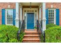 Charming entryway with blue door, brick steps, and black iron railings at 3499 Paces Ferry Se Cir, Smyrna, GA 30080