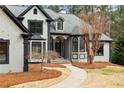 Beautiful front yard showcasing a winding walkway and well-maintained lawn leading to the home's entrance at 1066 Fairway Valley Dr, Woodstock, GA 30189