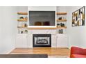 Inviting living room with a marble fireplace, floating shelves, and modern accents at 1836 Memorial Dr # 303, Atlanta, GA 30317