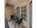 Inviting outdoor balcony featuring a small table and chairs, perfect for relaxing and enjoying the view at 1850 Cotillion Dr # 4218, Atlanta, GA 30338