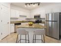 Well-lit kitchen boasts an island with seating, stainless steel appliances, and ample counter space at 1850 Cotillion Dr # 4218, Atlanta, GA 30338