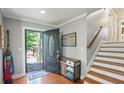 Open foyer features hardwood floors, staircase, and coat closet at 4856 Saddlerun Ln, Powder Springs, GA 30127