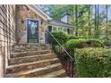 Inviting stone steps lead to the decorative front door with sidelights at 4856 Saddlerun Ln, Powder Springs, GA 30127