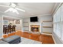 Cozy living room with fireplace and dining area at 4856 Saddlerun Ln, Powder Springs, GA 30127