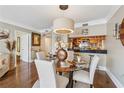 Dining area featuring a glass table, seating for four, with bar and kitchen view at 3481 Lakeside Ne Dr # 1103, Atlanta, GA 30326