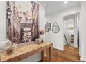 Stylish entryway with hardwood floors, designer console table, and artistic wall decor, showcasing modern elegance at 4855 Kendall Ct, Atlanta, GA 30342