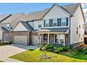 Charming two-story home with a combination brick and siding exterior and a two-car garage, surrounded by a green lawn at 517 Hyde Ridge Trl, Loganville, GA 30052