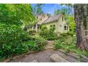 A charming home with a view of the side exterior, lush landscaping, and a quaint walkway at 2655 Appian Way, Decatur, GA 30030
