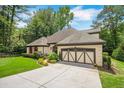 Beautiful one-story home featuring well-kept landscaping, a spacious driveway, and a 2-car garage at 2715 Woods Ridge Dr, Alpharetta, GA 30022