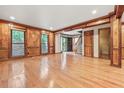 Spacious living room featuring hardwood floors, wood trim and bright windows at 3267 Rememberance Trce, Lawrenceville, GA 30044