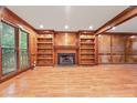 Cozy living room with custom built-ins flanking a classic fireplace at 3267 Rememberance Trce, Lawrenceville, GA 30044