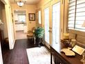 Elegant foyer with decorative rug, chandelier, dark wood floors, and view of the kitchen at 4040 Summit Dr, Marietta, GA 30068