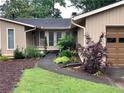Front exterior with a curved sidewalk, landscaped yard and covered front entrance at 4040 Summit Dr, Marietta, GA 30068