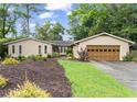 Charming single-story home with well-maintained lawn and an attached two-car garage at 4040 Summit Dr, Marietta, GA 30068