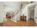 Grand foyer features hardwood floors, elegant staircase, and bright, open space for a welcoming entrance at 10310 Amberside Ct, Roswell, GA 30076