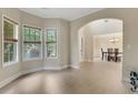 Bright living room with an archway leading to the dining area with plenty of natural light at 1411 Primrose Park Rd, Sugar Hill, GA 30518