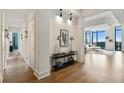 Hallway with art display leading into a bright and open living space with floor to ceiling windows at 3107 Peachtree Ne Rd # 2003 Aka Ph3, Atlanta, GA 30305