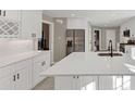 Contemporary kitchen showcases an island with sink, stainless fridge, bright countertops, and ample storage at 3017 Lana Ln, Marietta, GA 30066