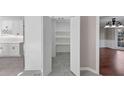 Bright, open walk-in pantry featuring tiled flooring and ample shelving for convenient kitchen storage at 3017 Lana Ln, Marietta, GA 30066