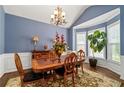 Elegant dining room with large windows, chandelier, and classic decor at 3480 Arbroath Dr, Douglasville, GA 30135