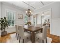 Elegant dining room featuring a modern chandelier and large windows at 4815 Westgate Drive, Cumming, GA 30040