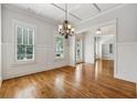 Elegant dining room with hardwood floors, chandelier, and bright windows at 4815 Westgate Drive, Cumming, GA 30040