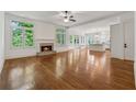 Bright living room featuring a fireplace, hardwood floors, and large windows at 4815 Westgate Drive, Cumming, GA 30040
