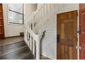 Bright entryway with gray stairs, white banister and a wooden door at 504 River Run Dr, Atlanta, GA 30350