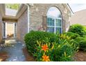Close up of Front door with well maintained flowerbeds at 5251 Centennial Hill Nw Dr, Acworth, GA 30102