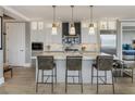 Modern kitchen with a large island, stylish pendant lights, and stainless steel appliances at 58 Canton St # 410, Alpharetta, GA 30009