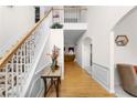 Spacious foyer featuring hardwood floors, white walls, a staircase, and an open view to the living area at 535 Sugar Gate Ct, Lawrenceville, GA 30044