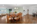 Open-concept dining room with hardwood floors conveniently located next to the kitchen and living room at 2221 Shallowford Rd, Marietta, GA 30066