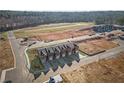 Aerial view of new townhomes, showcasing their layout and surrounding development area in a sunny landscape at 225 Ivey Ter, Temple, GA 30179