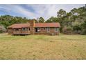 This house has an exterior with a spacious backyard and deck, perfect for outdoor living and entertainment at 5687 Highway 212, Covington, GA 30016