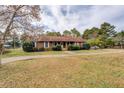 Charming single story home featuring a spacious front yard and mature trees at 5687 Highway 212, Covington, GA 30016