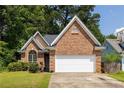 Traditional brick home with a manicured front yard, an arched window, and a two-car garage at 1026 Lester Se Ave, Atlanta, GA 30316