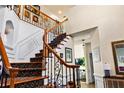 Bright foyer features a staircase with carpeted treads, wood and wrought iron banister and high ceilings at 5105 Riverthur Pl, Duluth, GA 30096