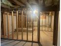 Unfinished basement with exposed framing, offering potential for customization at 1075 Crystal Water Dr, Lawrenceville, GA 30045