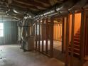 Spacious unfinished basement, featuring exposed ductwork and stairs to the upper level at 1075 Crystal Water Dr, Lawrenceville, GA 30045