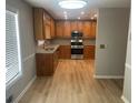 Well-lit kitchen features modern stainless steel appliances and wood-look flooring at 1075 Crystal Water Dr, Lawrenceville, GA 30045
